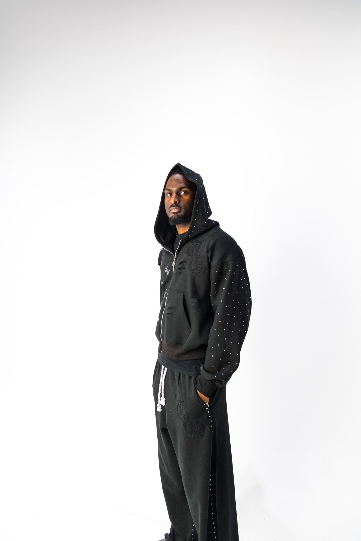 Black model front view of TG Rhinestone oversized, distressed, cropped, rhinestone jacket.