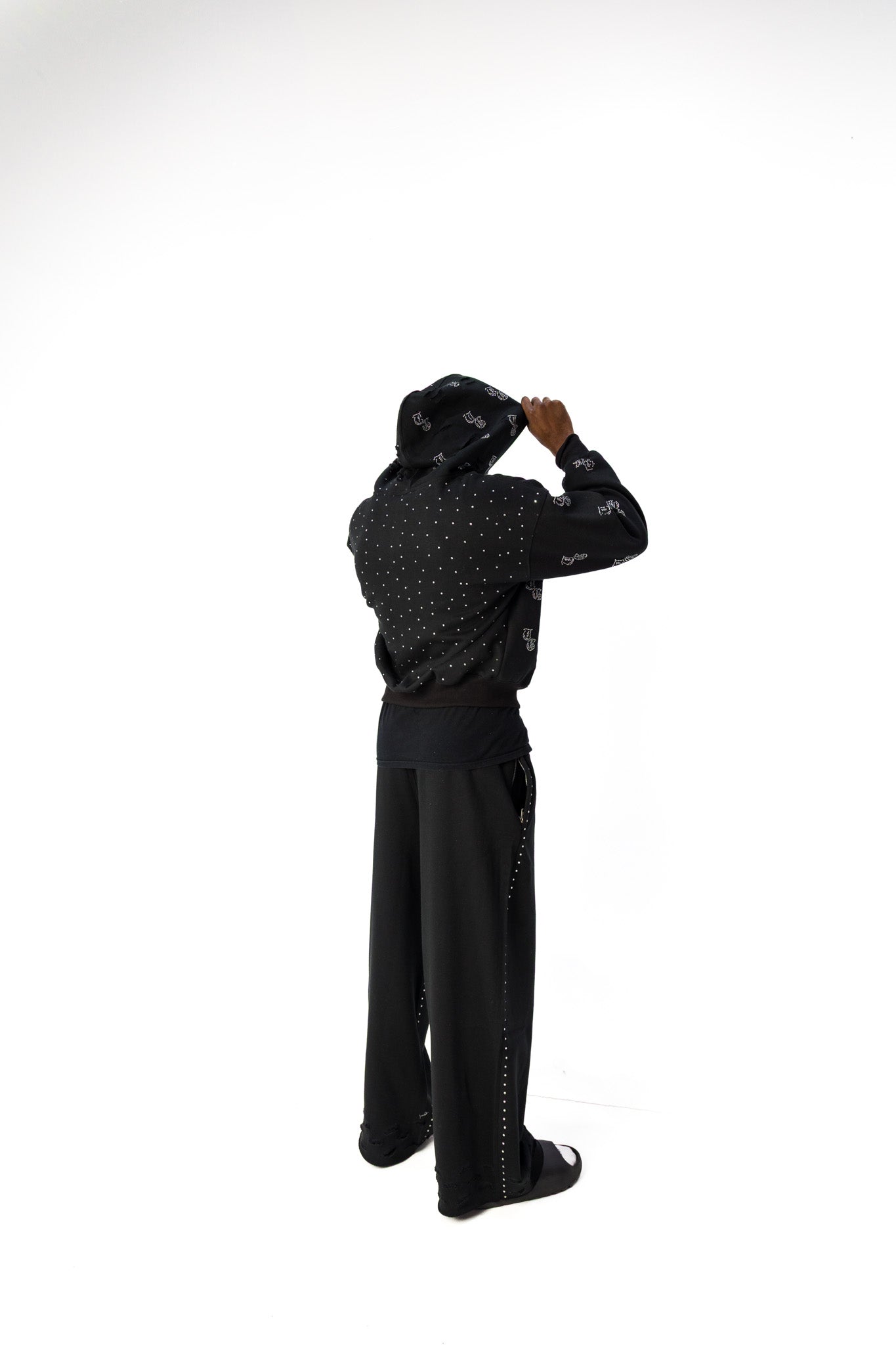 Black back model view of TG Rhinestone oversized, distressed rhinestone sweatpants. 