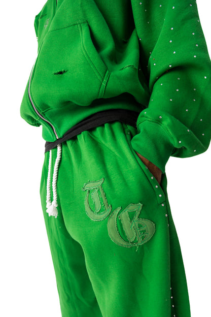 Green front detail view of TG Rhinestone oversized, distressed rhinestone sweatpants. 