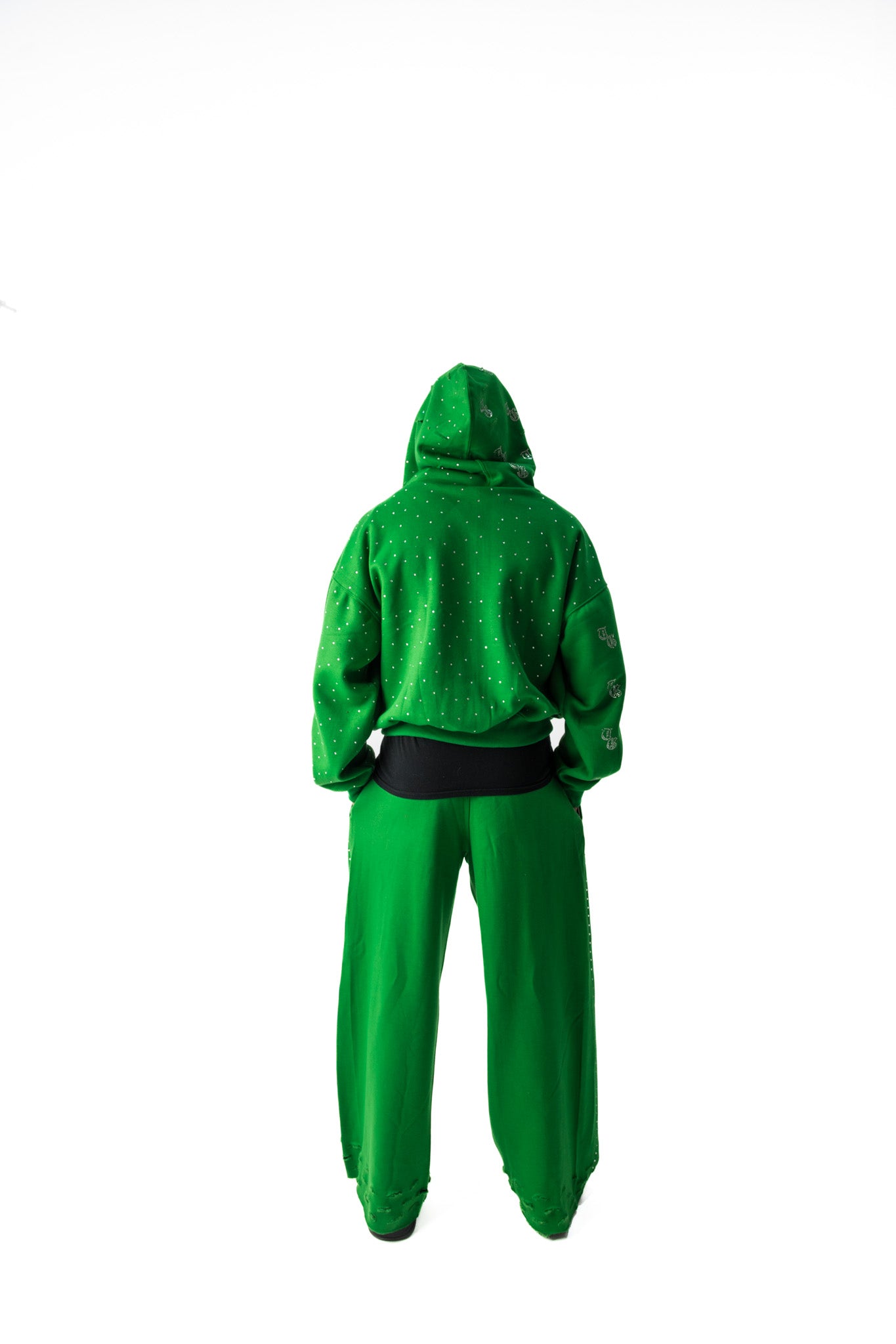 Green back model view of TG Rhinestone oversized, distressed rhinestone sweatpants. 