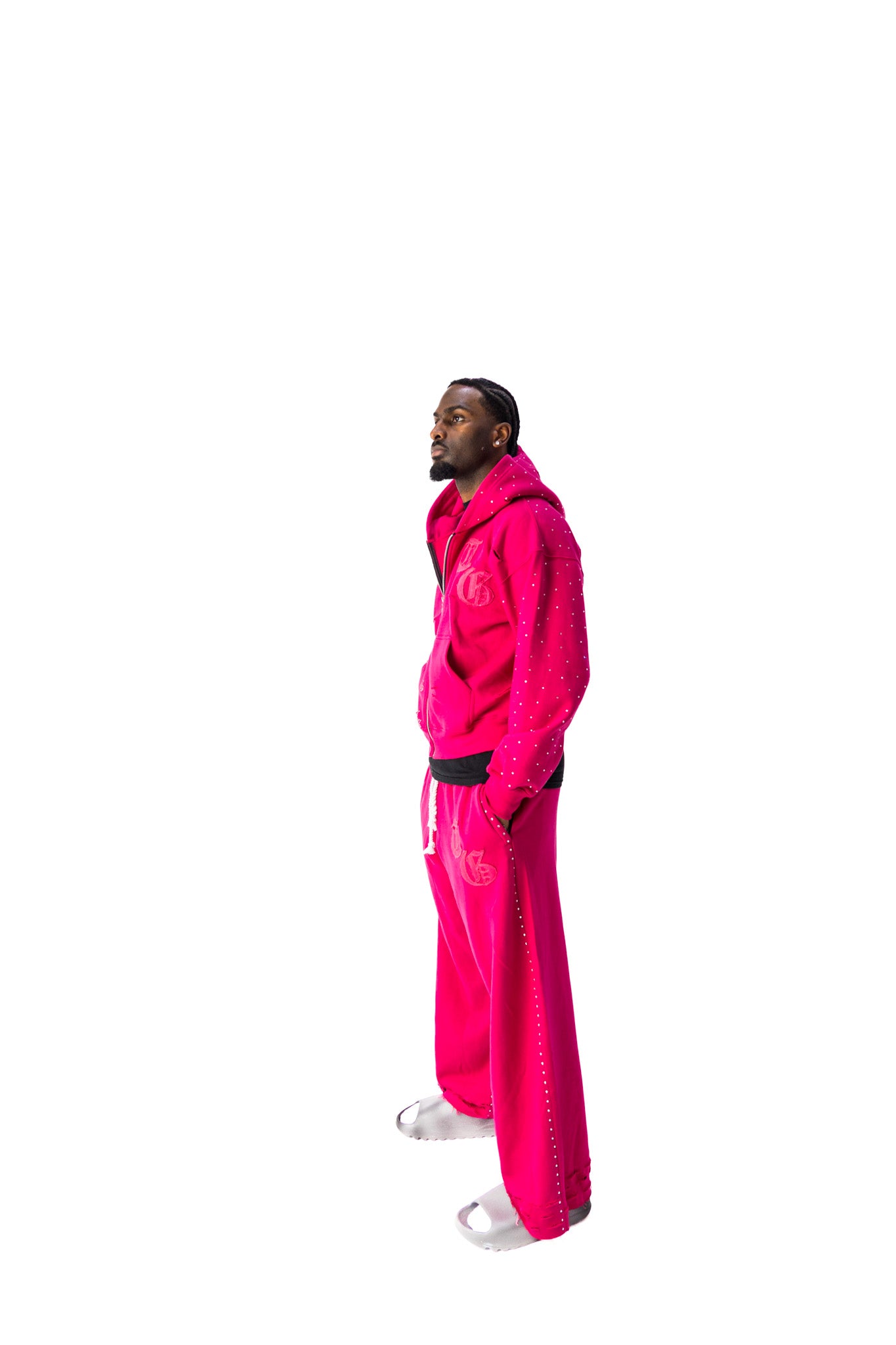 Pink model side view of TG Rhinestone oversized, distressed rhinestone sweatpants. 