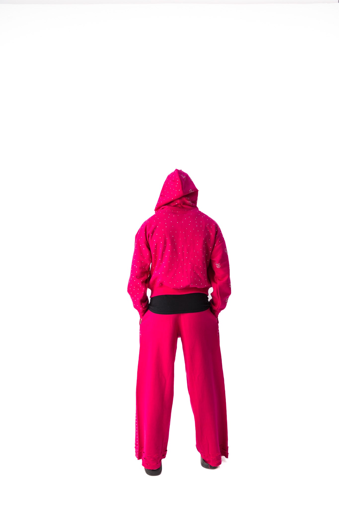 Pink model back view of TG Rhinestone oversized, distressed rhinestone sweatpants. 